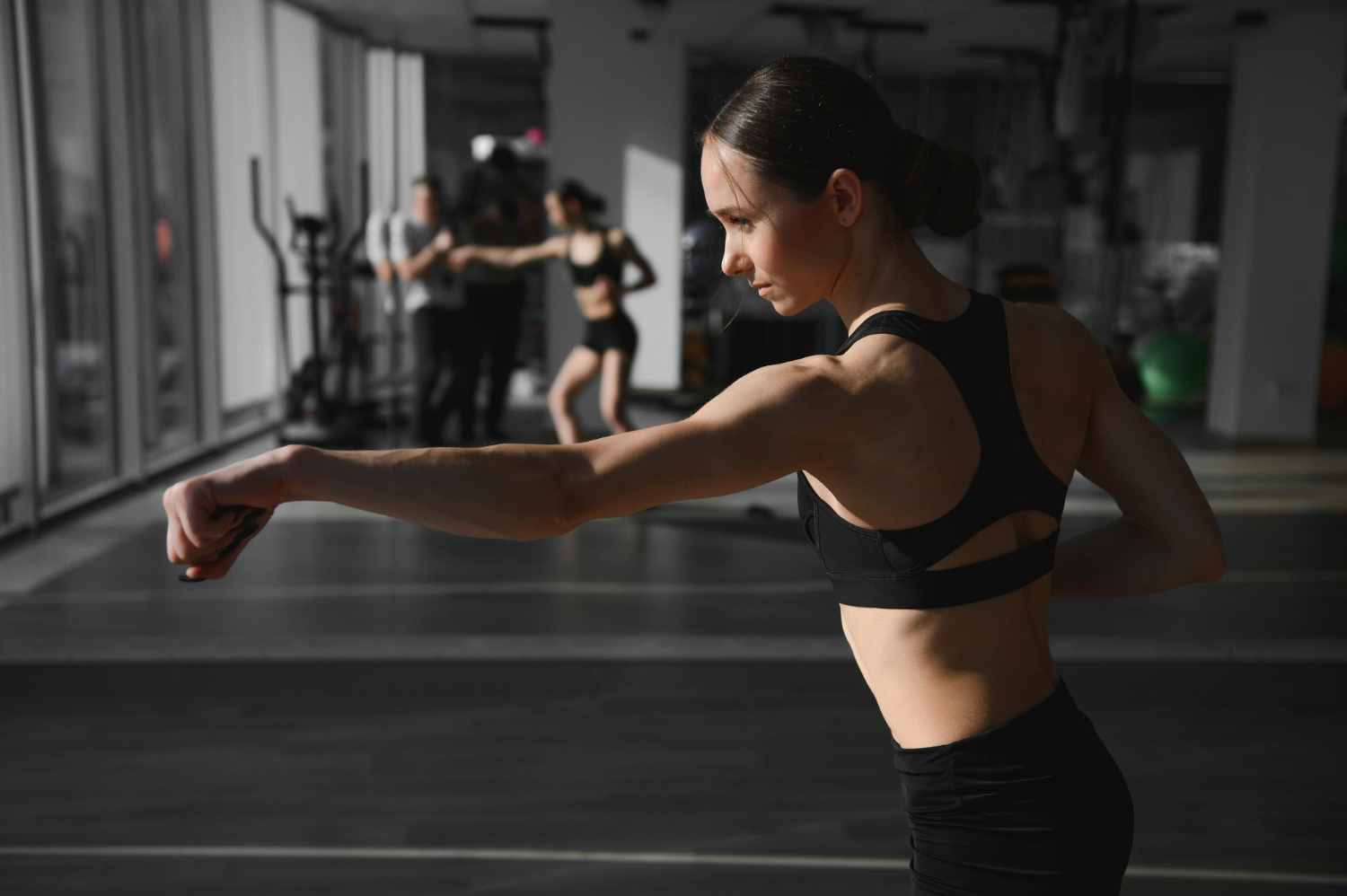 boxing woman during exercisegray background