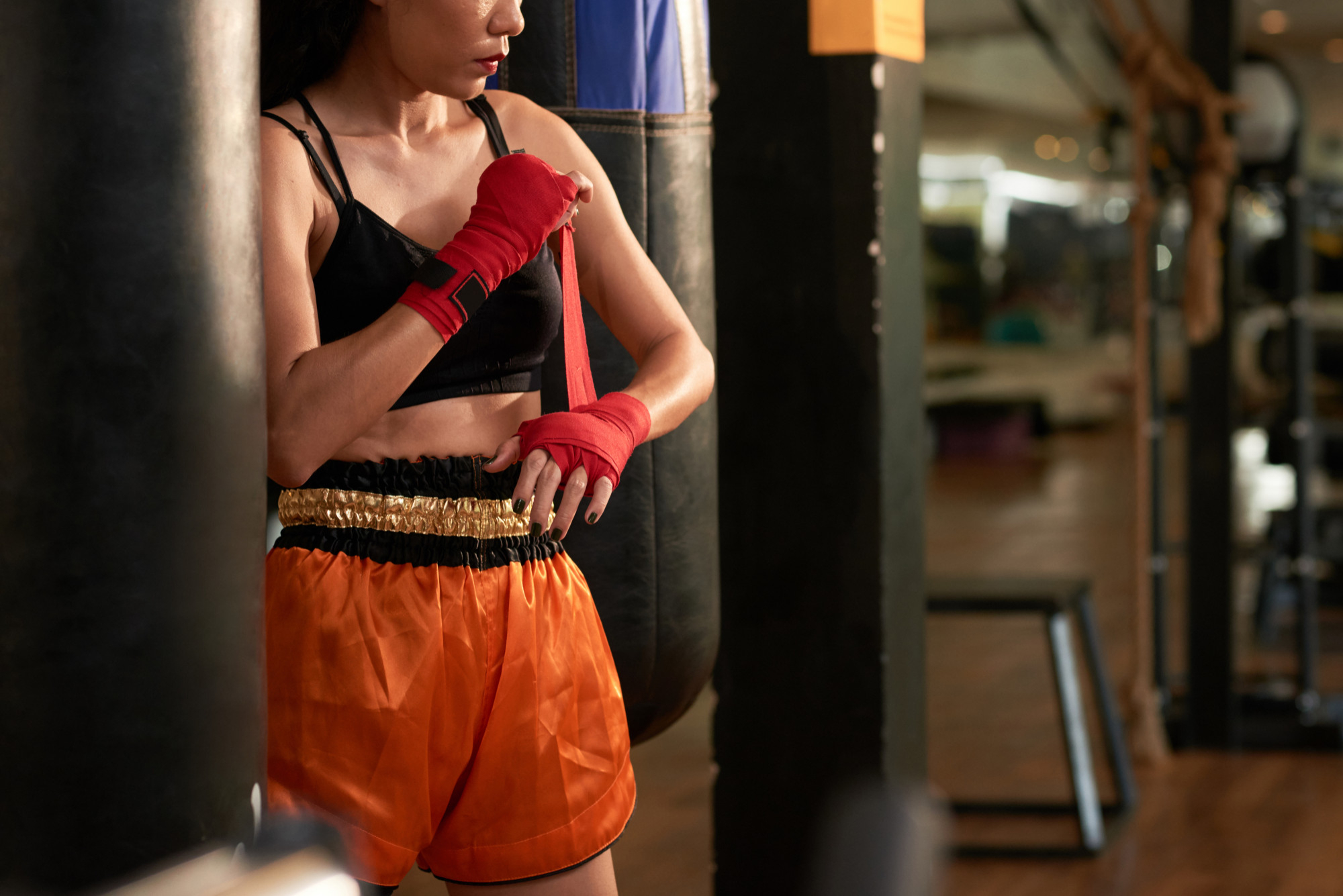 cropped sportswoman preparing boxing exercise gym